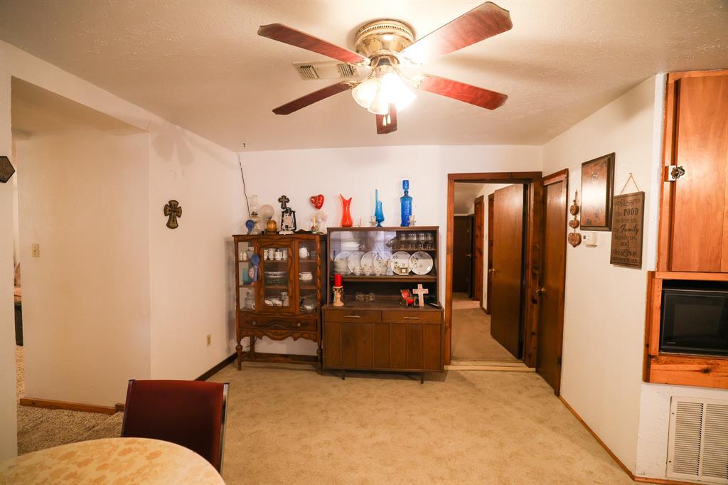 6482 County Road 4700 Commerce, TX 75428 - Photo 14 of 23 a living room with furniture and a flat screen tv
