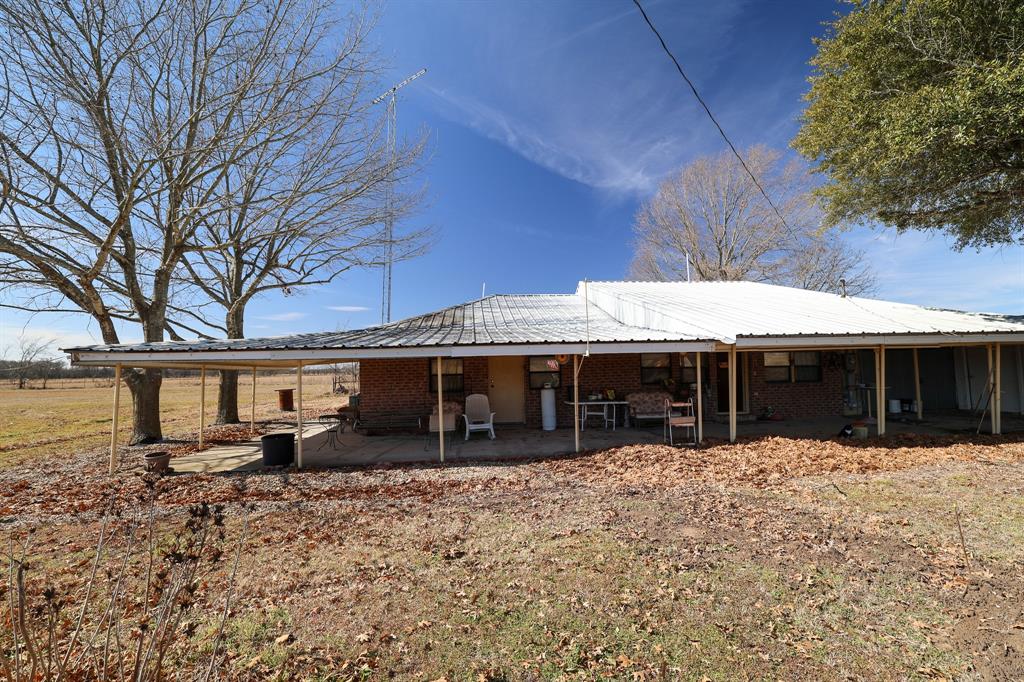 6482 County Road 4700 Commerce, TX 75428 - Photo 16 of 23 a front view of a house with a yard covered in snow