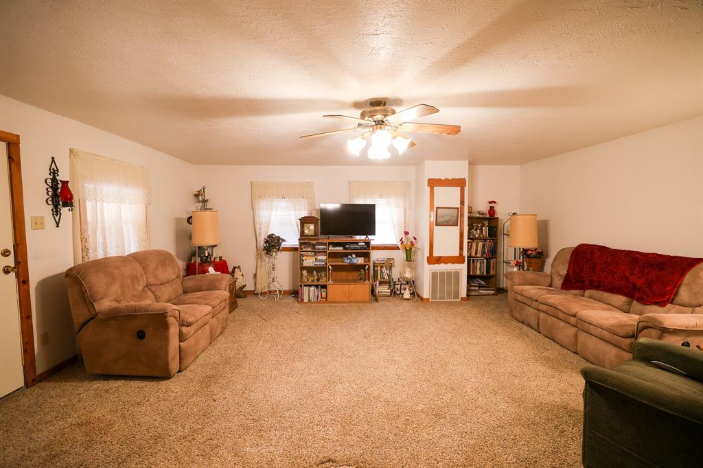 6482 County Road 4700 Commerce, TX 75428 - Photo 4 of 23 a living room with furniture and a flat screen tv