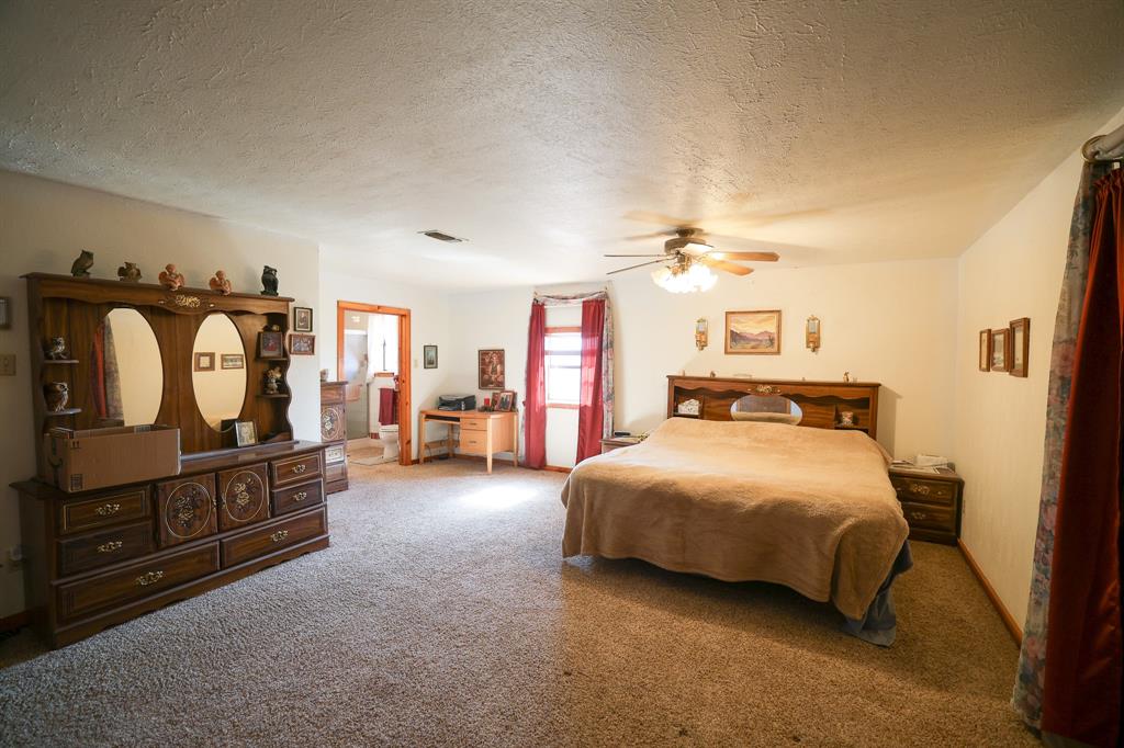 6482 County Road 4700 Commerce, TX 75428 - Photo 6 of 23 a bedroom with a bed and dresser