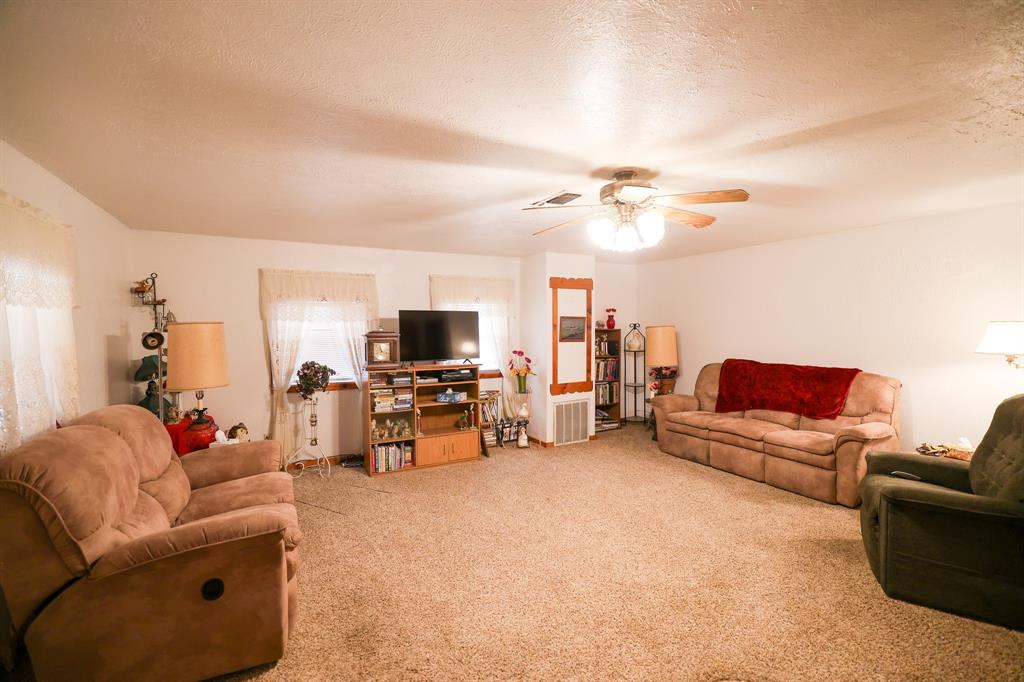6482 County Road 4700 Commerce, TX 75428 - Photo 8 of 23 a living room with furniture and a flat screen tv