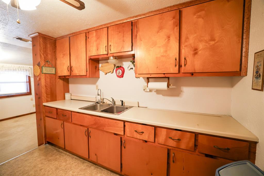 6482 County Road 4700 Commerce, TX 75428 - Photo 10 of 23 a bathroom with a sink and a mirror