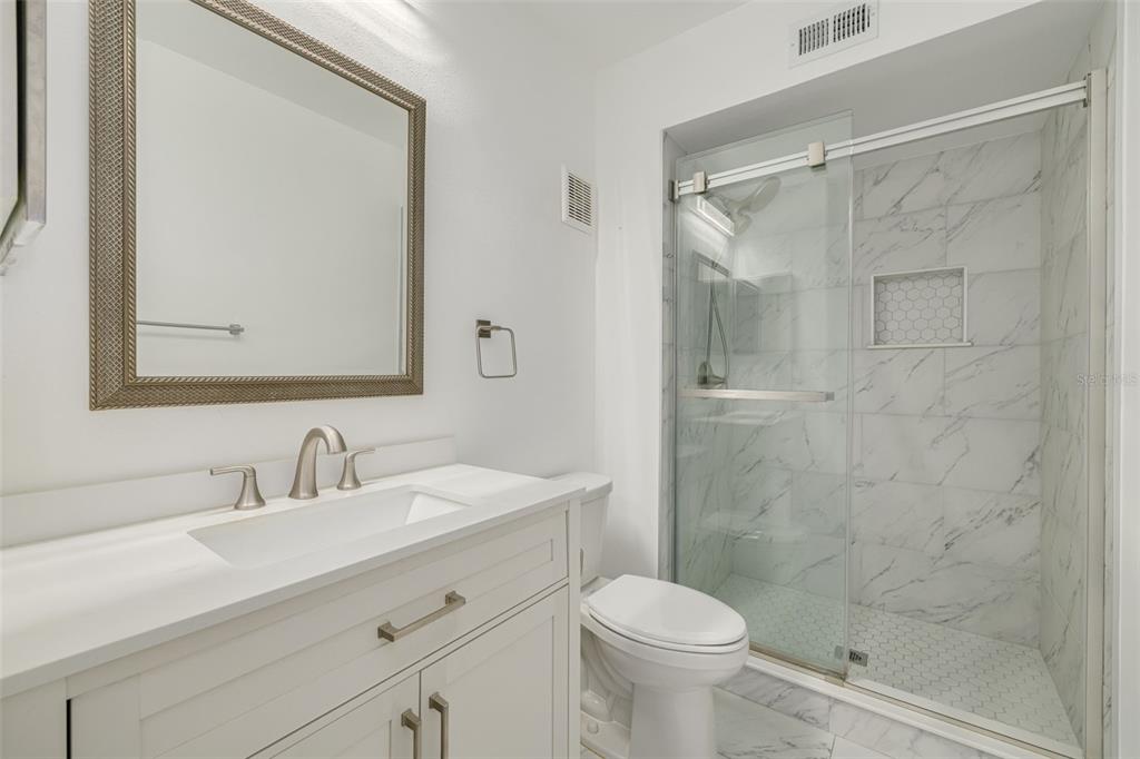3590 Magnolia Ridge Circle, Unit C1103 Palm Harbor, FL 34684 - Photo 15 of 31 a bathroom with a sink a toilet and shower