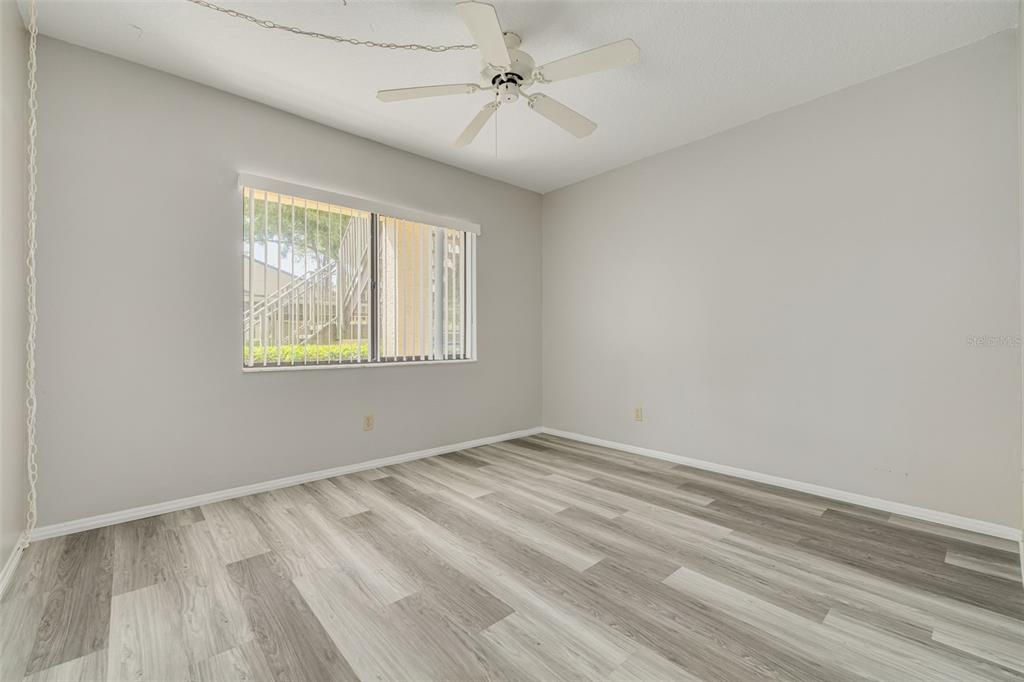 3590 Magnolia Ridge Circle, Unit C1103 Palm Harbor, FL 34684 - Photo 16 of 31 wooden floor in an empty room with a window