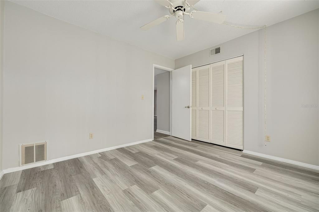 3590 Magnolia Ridge Circle, Unit C1103 Palm Harbor, FL 34684 - Photo 17 of 31 a view of an empty room with wooden floor