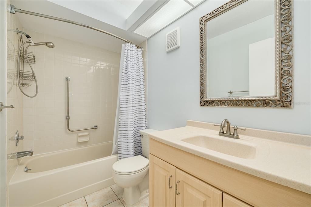 3590 Magnolia Ridge Circle, Unit C1103 Palm Harbor, FL 34684 - Photo 18 of 31 a bathroom with a sink a toilet and shower