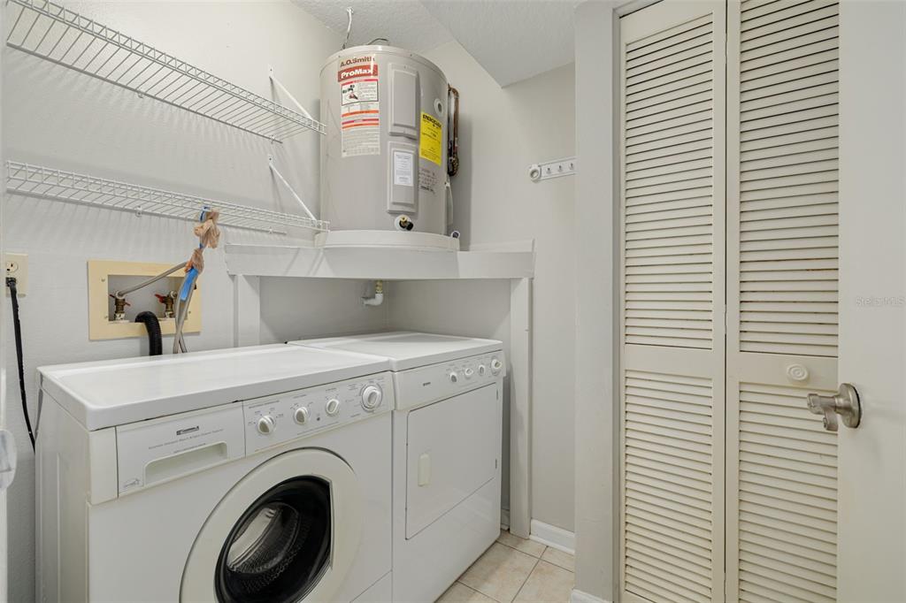3590 Magnolia Ridge Circle, Unit C1103 Palm Harbor, FL 34684 - Photo 19 of 31 a utility room with dryer and washer