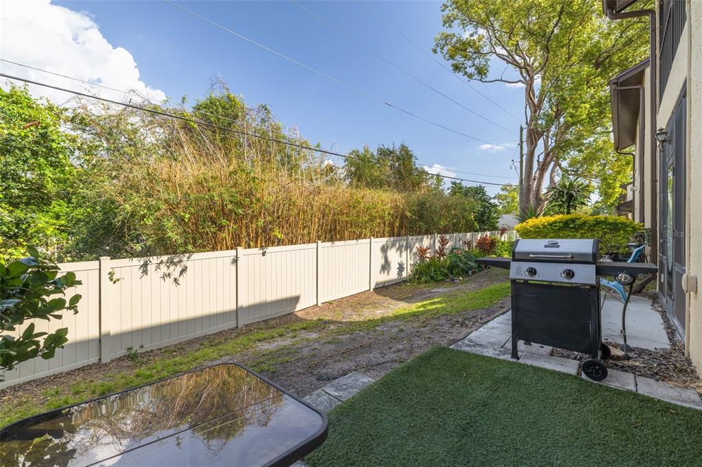 3590 Magnolia Ridge Circle, Unit C1103 Palm Harbor, FL 34684 - Photo 21 of 31 a view of a backyard with couches chair and a fire pit