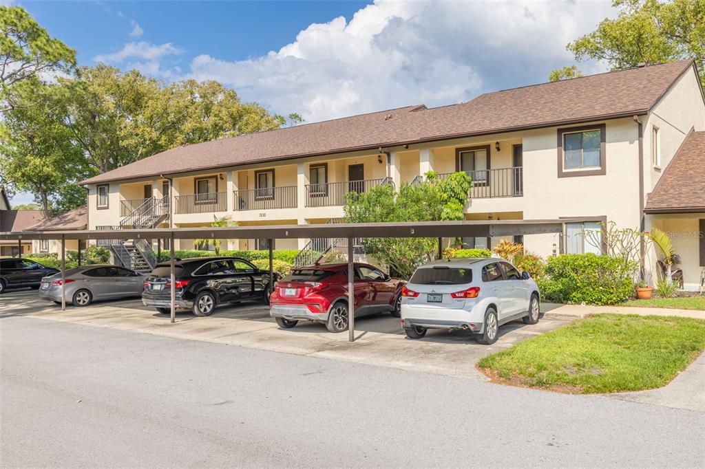 3590 Magnolia Ridge Circle, Unit C1103 Palm Harbor, FL 34684 - Photo 23 of 31 a car parked in front of a house