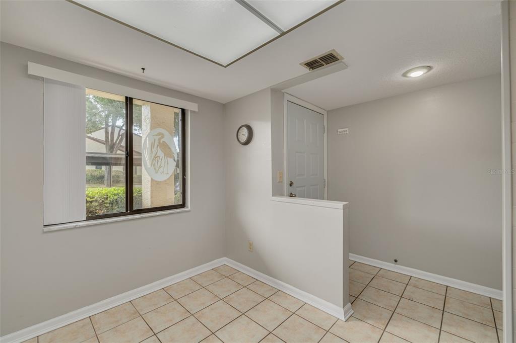 3590 Magnolia Ridge Circle, Unit C1103 Palm Harbor, FL 34684 - Photo 4 of 31 wooden floor in an empty room with a window