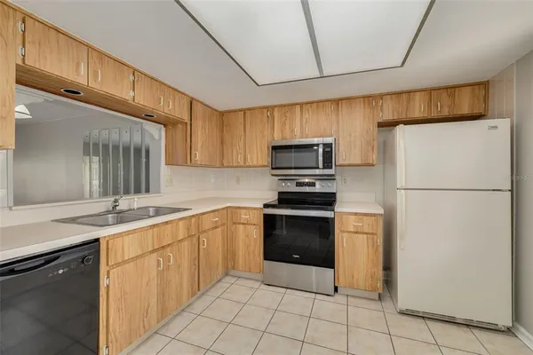 a kitchen with a sink appliances and cabinets
