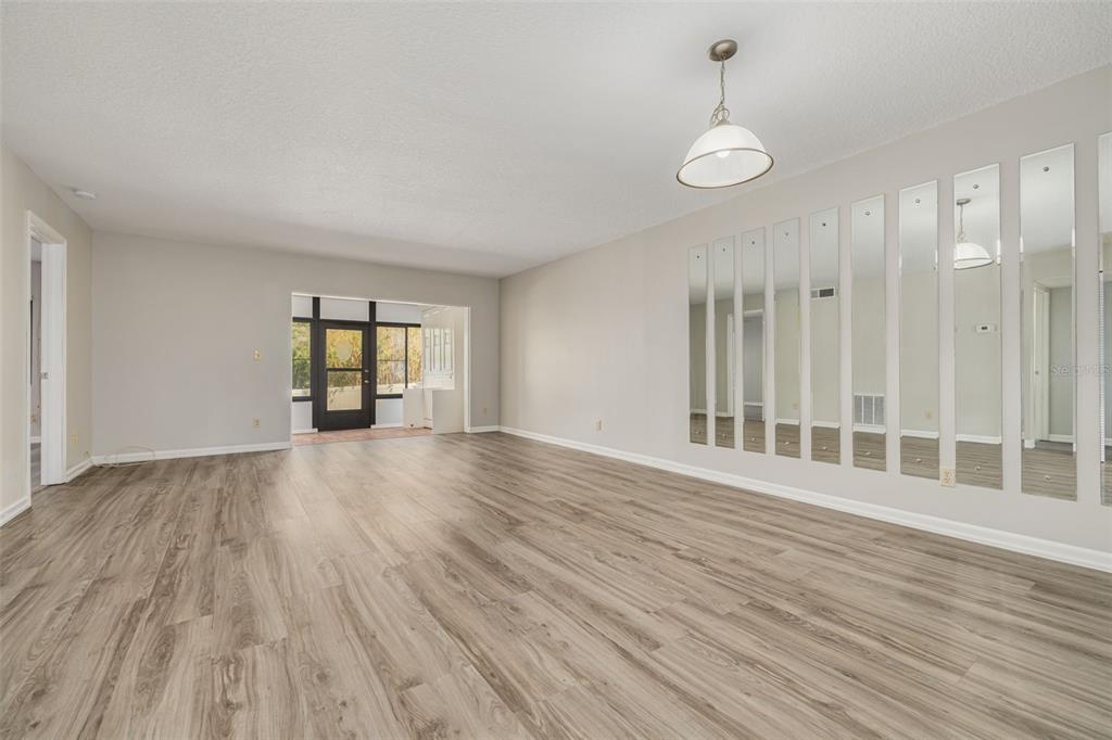 3590 Magnolia Ridge Circle, Unit C1103 Palm Harbor, FL 34684 - Photo 7 of 31 a view of wooden floor and windows in a room