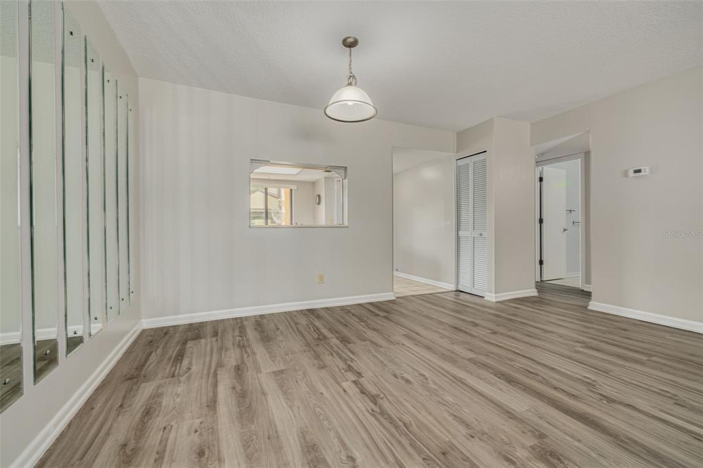 3590 Magnolia Ridge Circle, Unit C1103 Palm Harbor, FL 34684 - Photo 10 of 31 a view of empty room with wooden floor and fan