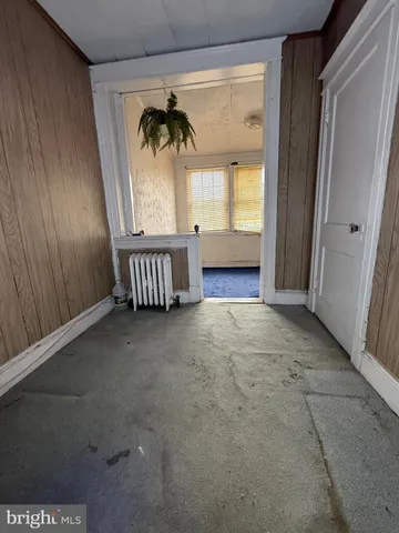 a view of a room with a window and wooden floor