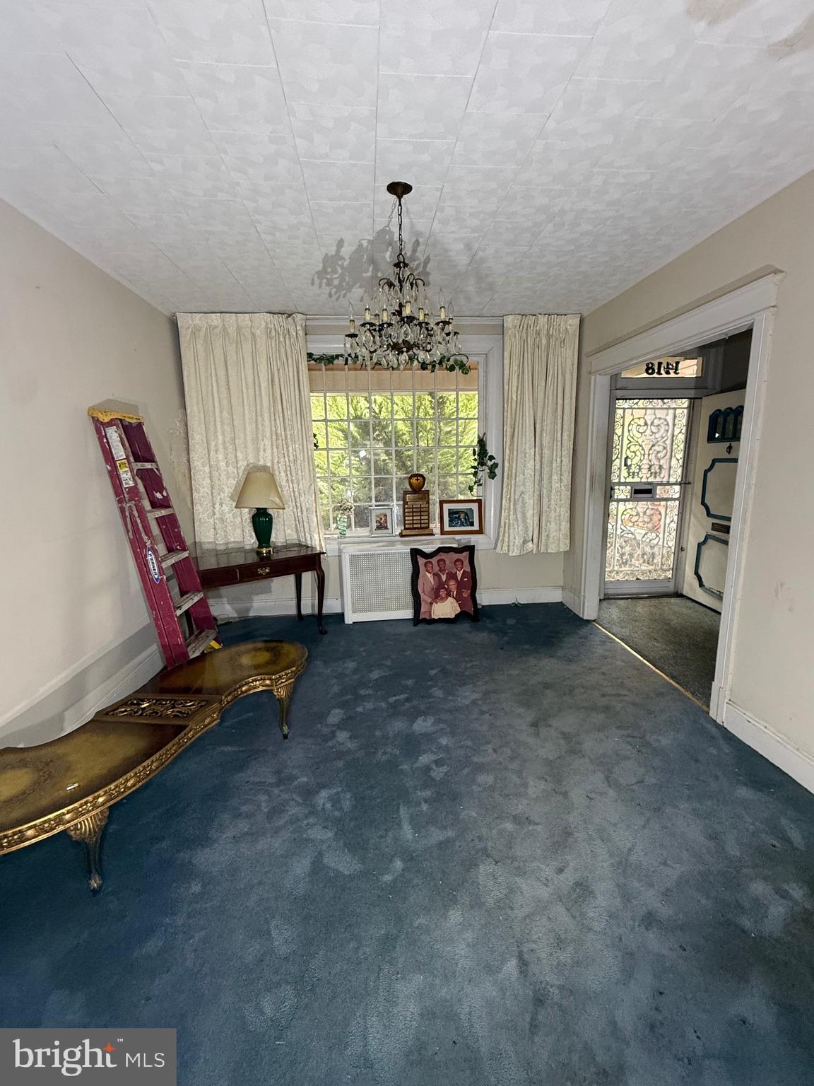 1418 E Street Northeast Washington, DC 20002 - Photo 3 of 17 a living room with furniture and a chandelier