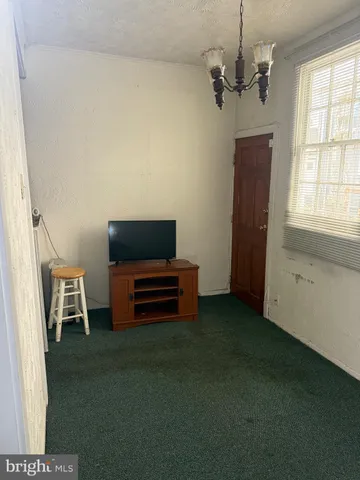 a view of a livingroom with furniture and a window