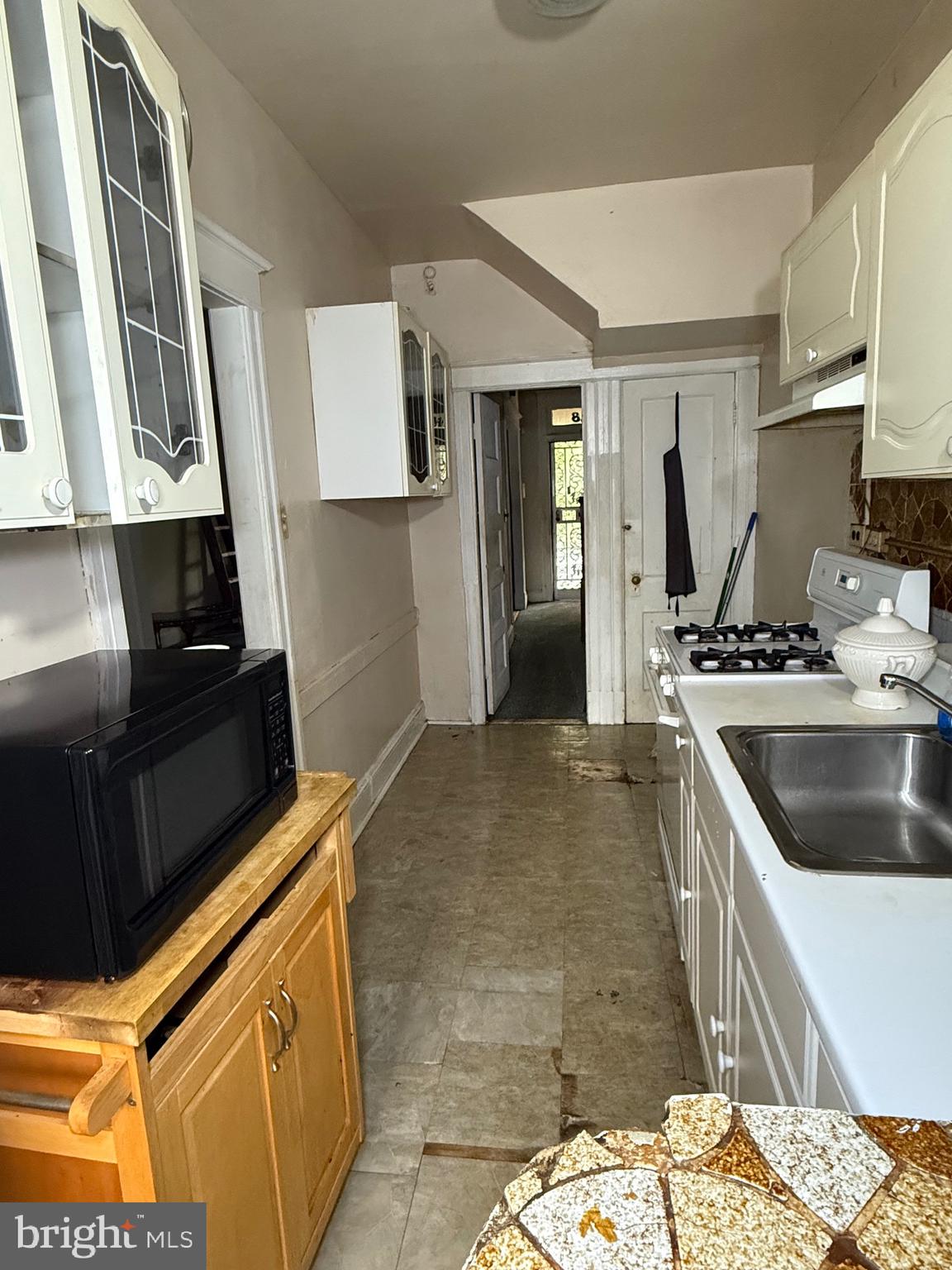 1418 E Street Northeast Washington, DC 20002 - Photo 8 of 17 a kitchen with a sink a stove and refrigerator