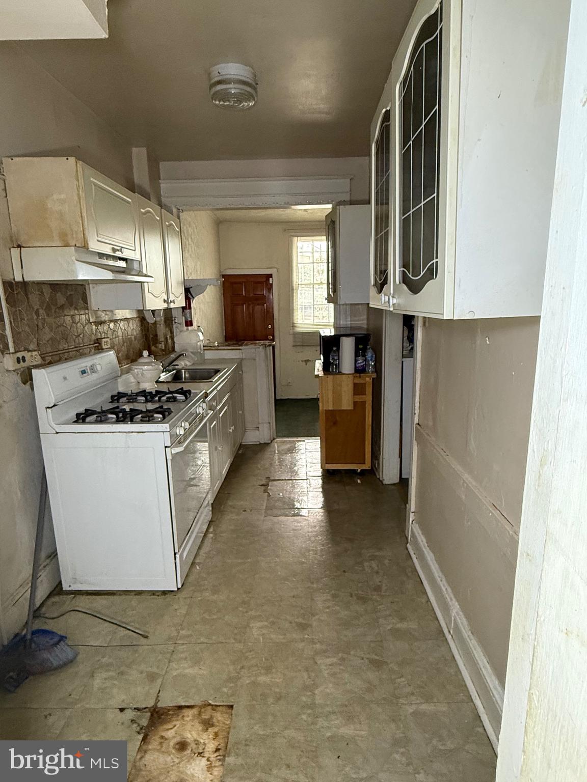 1418 E Street Northeast Washington, DC 20002 - Photo 9 of 17 a kitchen with stainless steel appliances a sink stove and cabinets