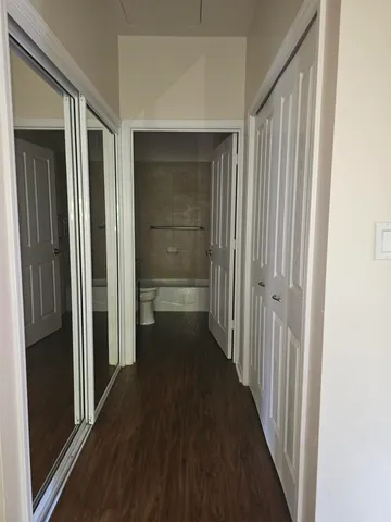 a view of a hallway with a wooden floors