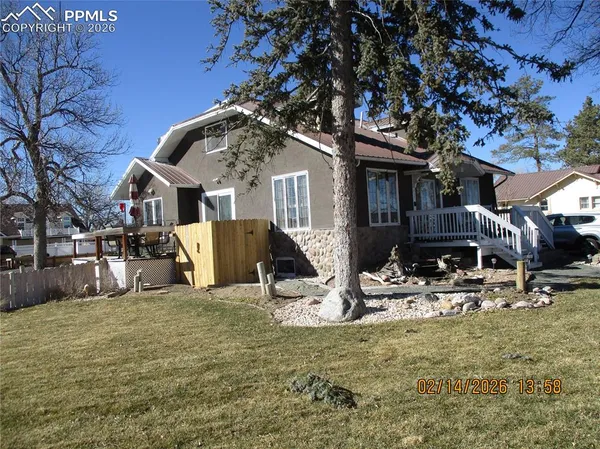 a view of a house with a large tree
