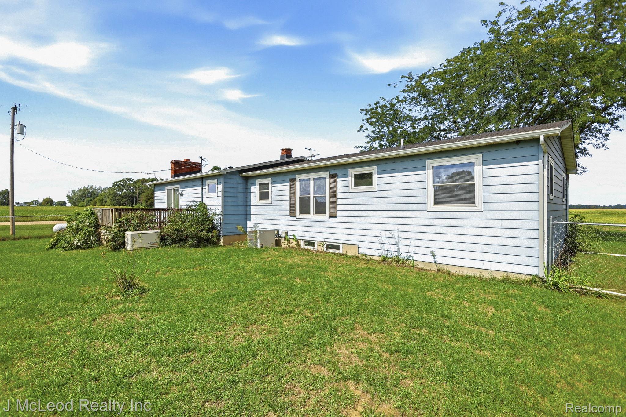 9481 Swaffer Road Vassar, MI 48768 - Photo 34 of 39 Light blue siding exterior with white trim windows