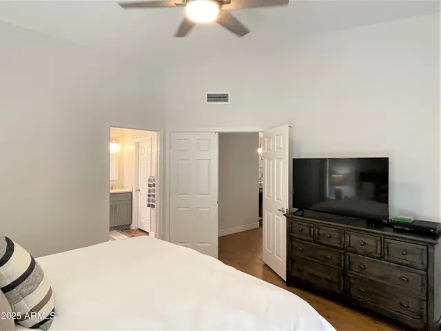 a bedroom with a bed and a flat screen tv