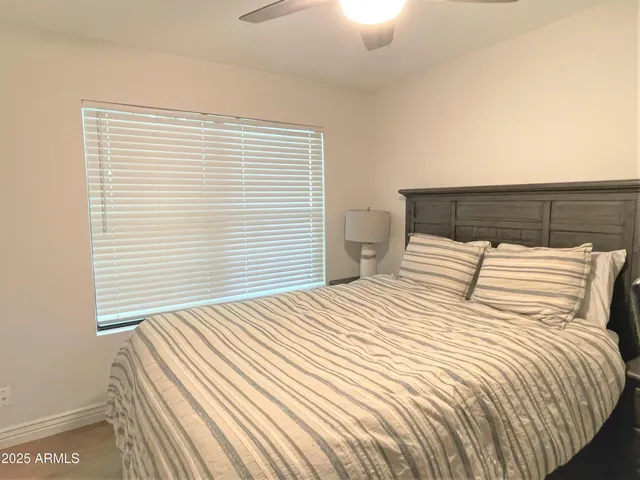a large bed sitting in a bedroom next to a window