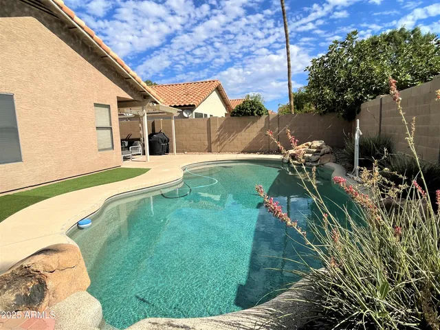 a backyard of a house with table and chairs