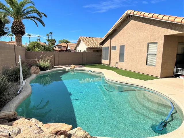 a backyard of a house with table and chairs