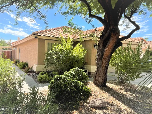 a view of a house with a tree