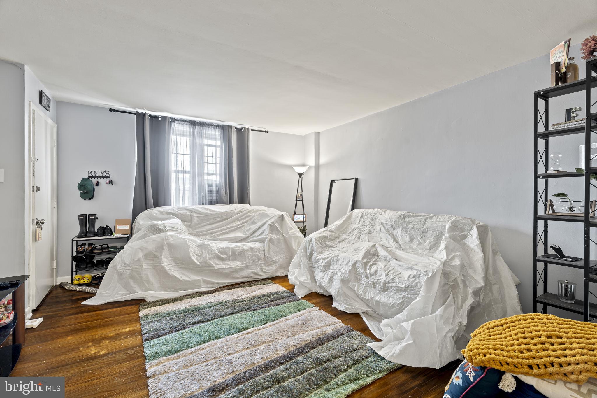 6014 Oakland Street Philadelphia, PA 19149 - Photo 3 of 13 a bedroom with two beds and painting on the wall
