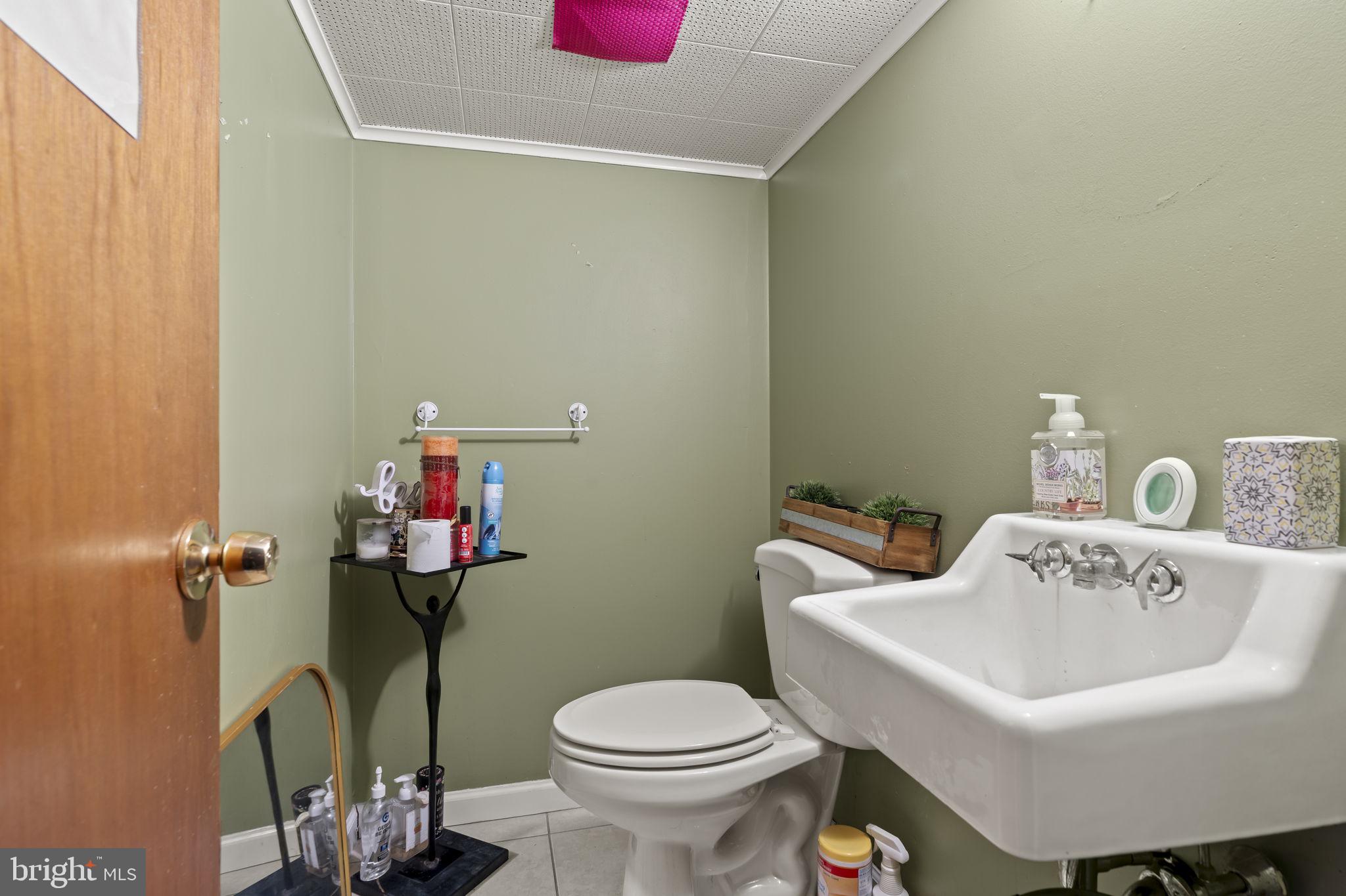 6014 Oakland Street Philadelphia, PA 19149 - Photo 9 of 13 a white toilet sitting next to a bathroom sink