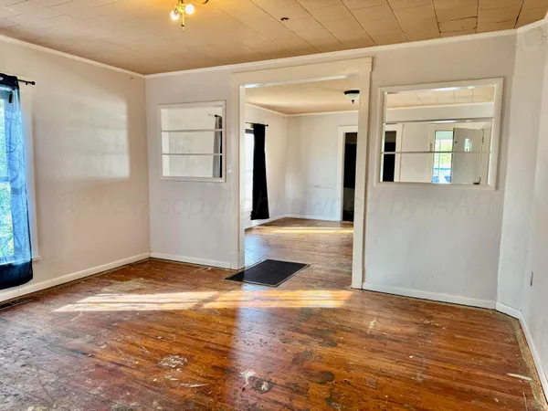 a view of empty room with wooden floor