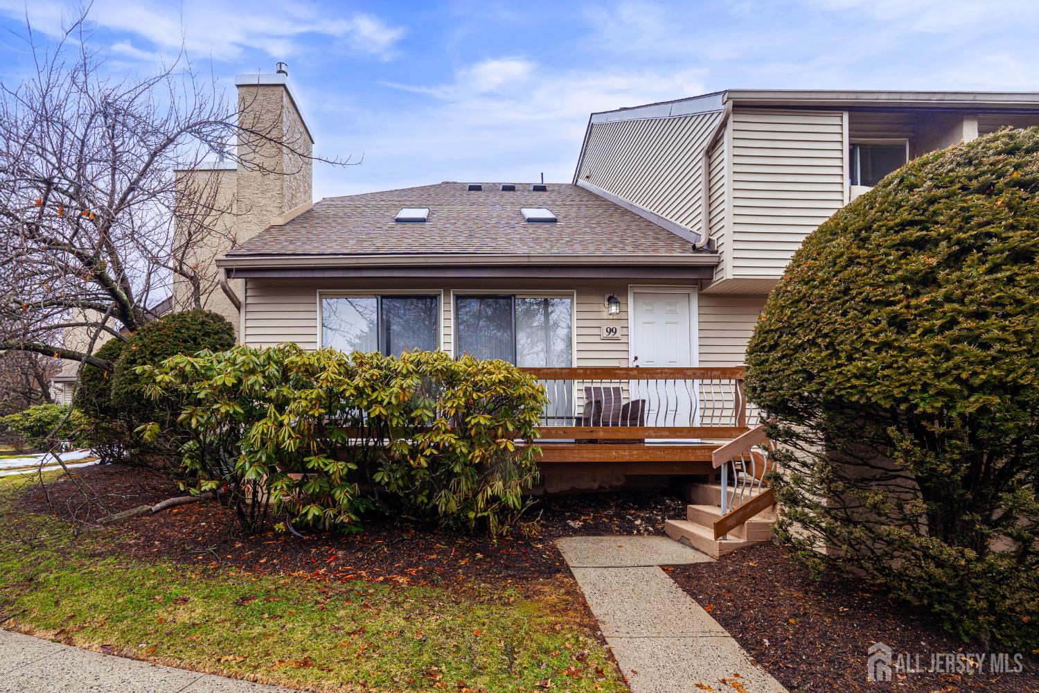 a front view of a house with a garden