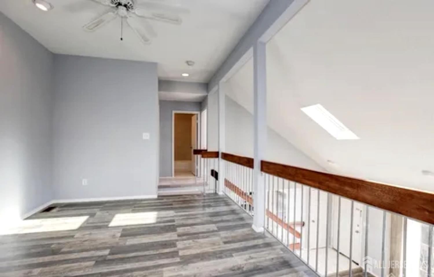 99 Kelly Drive Edison, NJ 08820 - Photo 24 of 29 a view of a hallway with wooden floor and chandelier