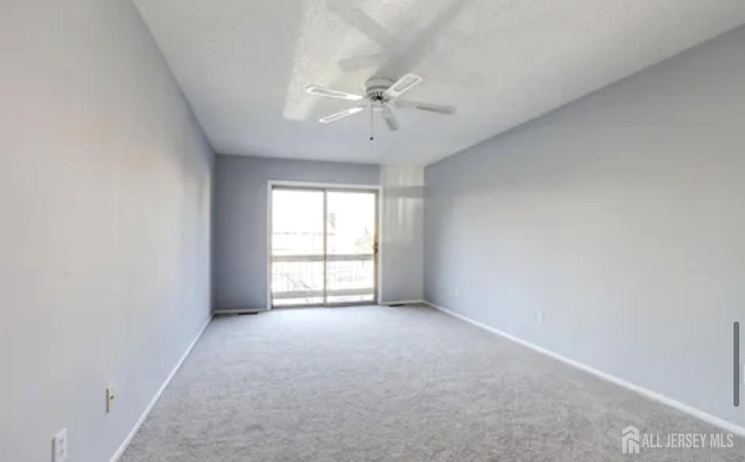 99 Kelly Drive Edison, NJ 08820 - Photo 26 of 29 an empty room with chandelier fan and windows