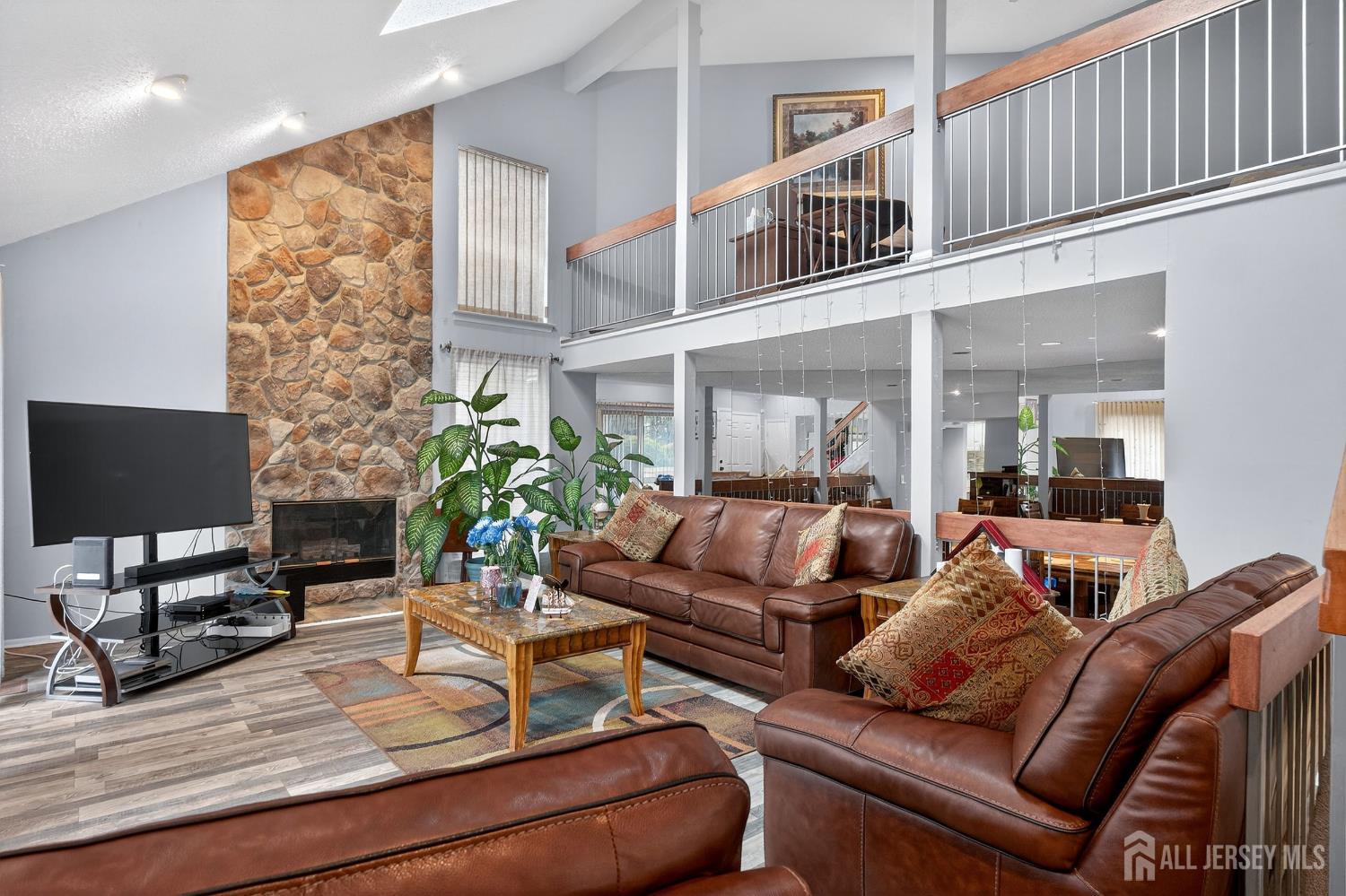 99 Kelly Drive Edison, NJ 08820 - Photo 4 of 29 a living room with furniture a fireplace and a flat screen tv