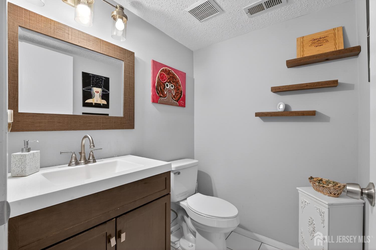99 Kelly Drive Edison, NJ 08820 - Photo 8 of 29 a bathroom with a toilet sink and mirror