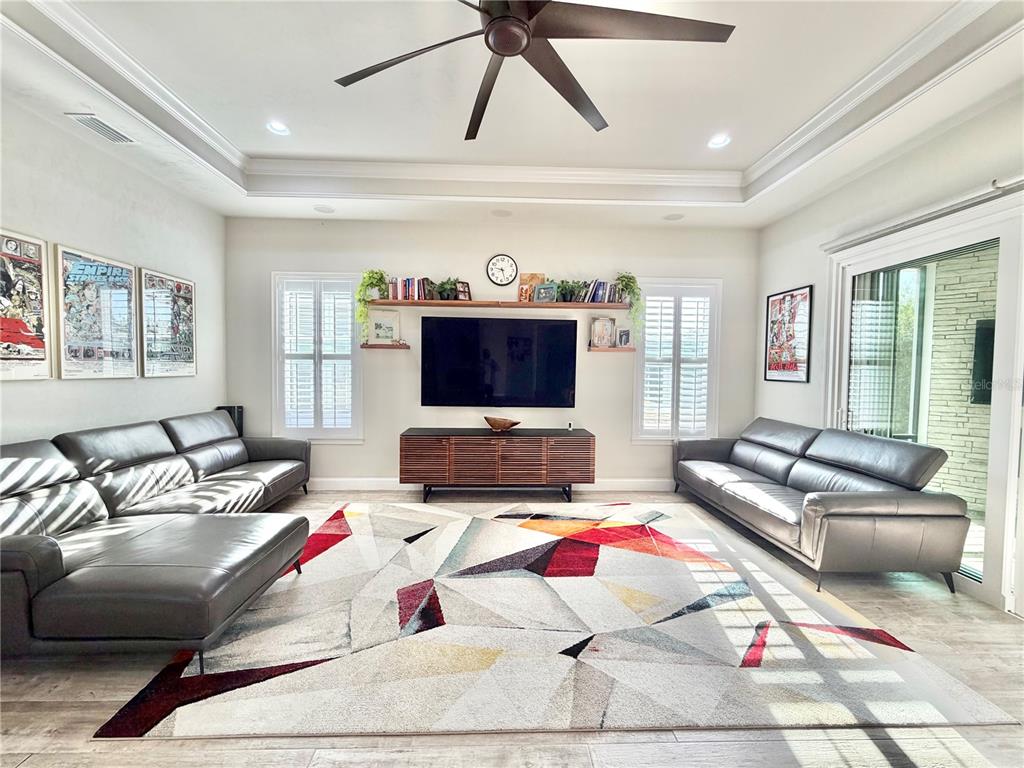 11931 Southwest 32nd Lane Gainesville, FL 32608 - Photo 11 of 78 a living room with a couch and a flat screen tv