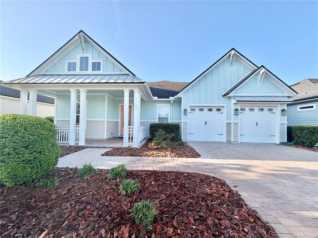 11931 Southwest 32nd Lane Gainesville, FL 32608 - Photo 2 of 78 a front view of a house with a yard and garage
