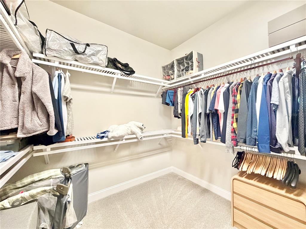 11931 Southwest 32nd Lane Gainesville, FL 32608 - Photo 28 of 78 a view of walk in closet with clothes and shoes