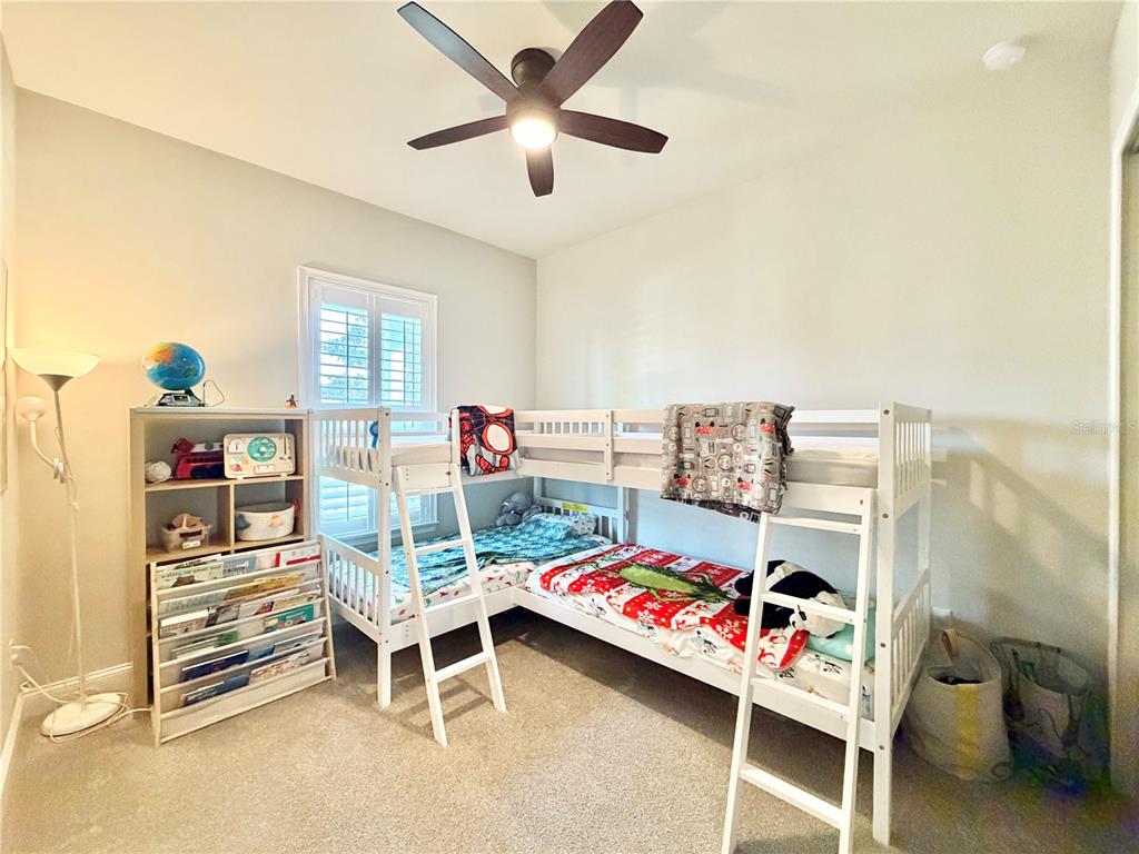11931 Southwest 32nd Lane Gainesville, FL 32608 - Photo 29 of 78 a bedroom with a bed and a chandelier