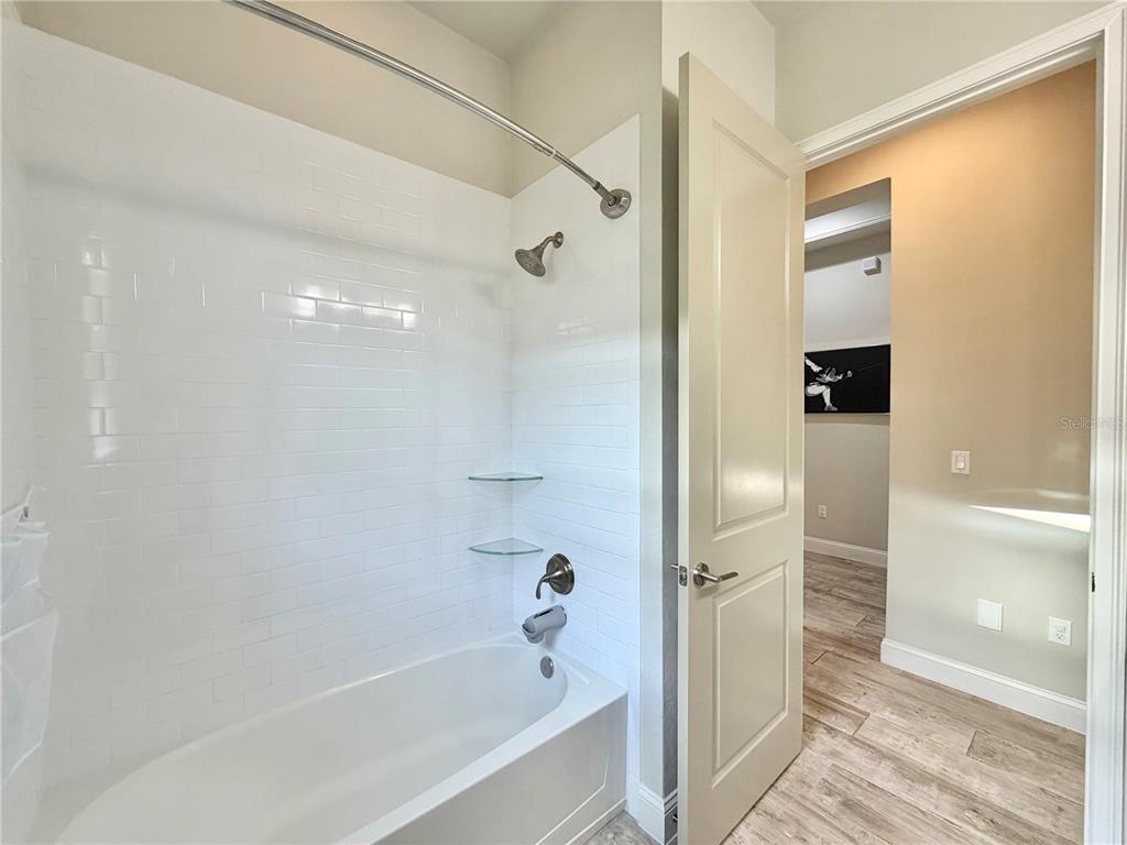 11931 Southwest 32nd Lane Gainesville, FL 32608 - Photo 32 of 78 a bathroom with a bathtub and a shower