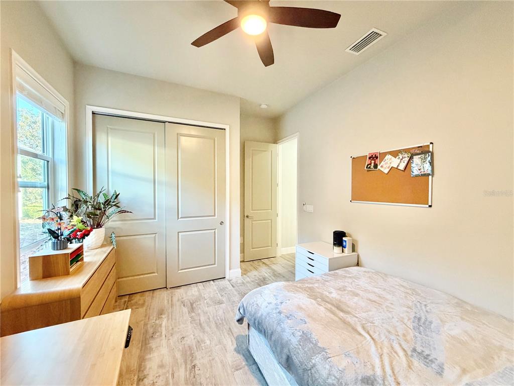 11931 Southwest 32nd Lane Gainesville, FL 32608 - Photo 35 of 78 a bedroom with a bed and a large mirror