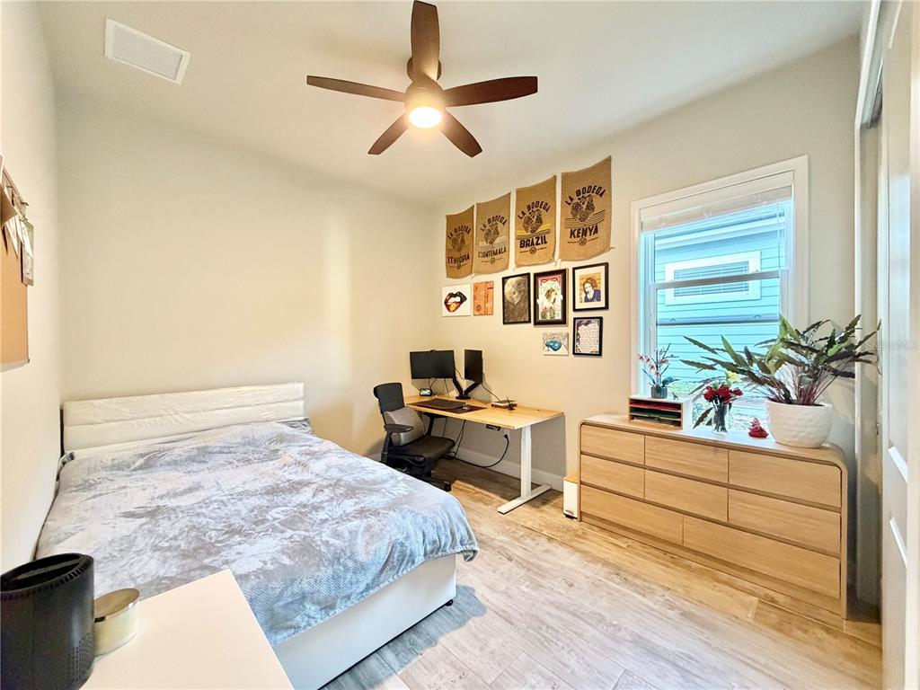 11931 Southwest 32nd Lane Gainesville, FL 32608 - Photo 38 of 78 a bedroom with a bed and a potted plant