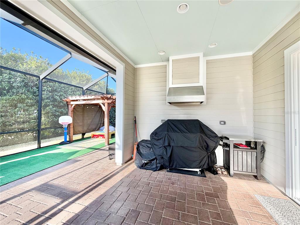 11931 Southwest 32nd Lane Gainesville, FL 32608 - Photo 45 of 78 a view of a patio with a table and chairs and floor to ceiling window