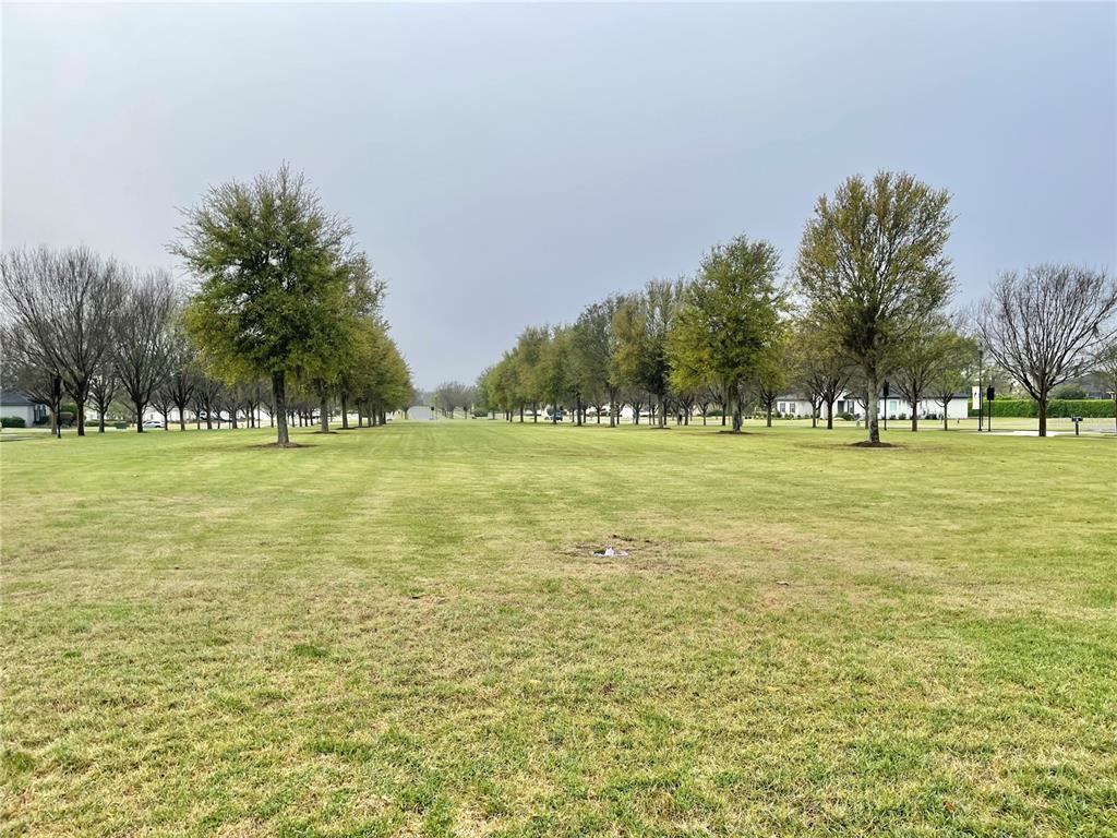 11931 Southwest 32nd Lane Gainesville, FL 32608 - Photo 76 of 78 a view of a green field with trees in the background
