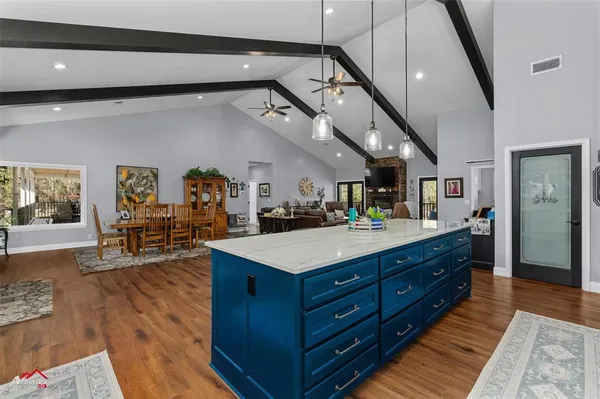 a kitchen with granite countertop white cabinets and stainless steel appliances