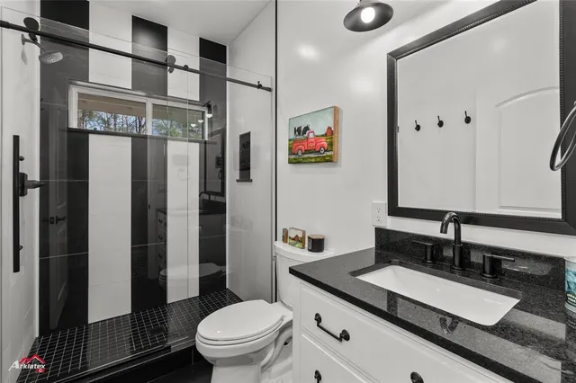 a aerial view of a house with swimming pool and large trees