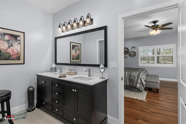 a spacious bedroom with a bed and a flat screen tv